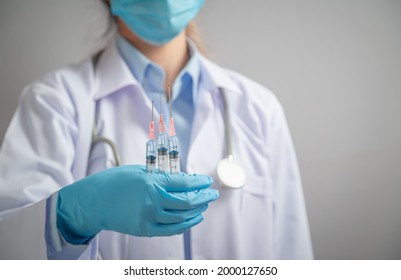 Doctor or scientist holding  syringe with liquid vaccines booster. fight against virus covid-19 coronavirus, Vaccination and immunization. diseases,medical care,science, vaccine booster concept. - Shutterstock ID 2000127650