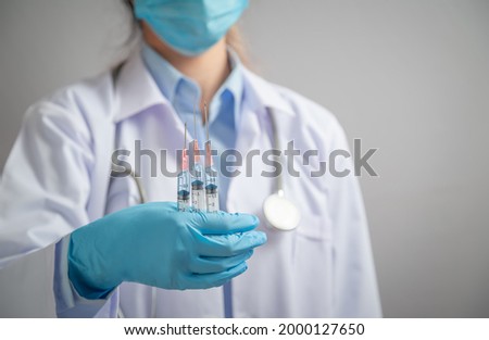 Doctor or scientist holding  syringe with liquid vaccines booster. fight against virus covid-19 coronavirus, Vaccination and immunization. diseases,medical care,science, vaccine booster concept.
