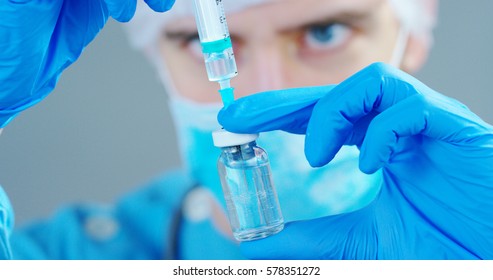 A Doctor Or Scientist In Laboratory Holding A Syringe With Liquid Vaccines For Children Or Older Adults, Or Cure Animal Diseases. Concept:diseases,medical Care,science, Anesthesia,euthanasia,diabetes.