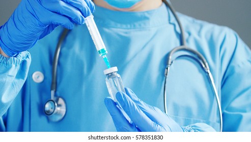 A Doctor Or Scientist In Laboratory Holding A Syringe With Liquid Vaccines For Children Or Older Adults, Or Cure Animal Diseases. Concept:diseases,medical Care,science, Anesthesia,euthanasia,diabetes.