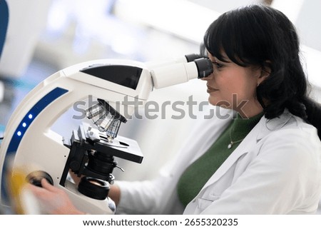 Doctor scientist using microscope in laboratory
