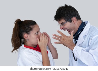 Doctor screams and yells at the poor scared and disconsolate nurse. Concept of bullying on nurses in healthcare