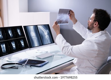 Doctor Screening Knee Bone X Ray On Computer