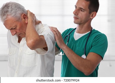 Doctor and senior male patient suffering from back pain during medical exam. - Powered by Shutterstock