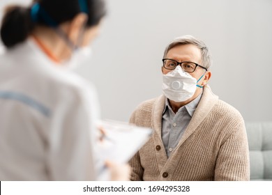 Doctor And Senior Man Wearing Facemasks During Coronavirus And Flu Outbreak. Virus And Illness Protection, Home Quarantine. COVID-2019