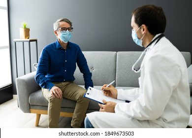 Doctor With Senior Patient Living At Home In Mask