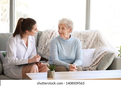 Doctor With Senior Woman In Nursing Home