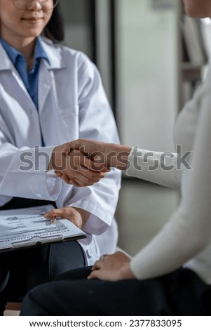 Doctor shakes hands with his patient in the office, after successful treatment of specialty and delighted patients returned home, a handshake concept to congratulate.