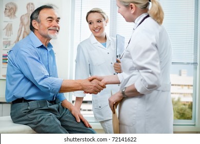 Doctor Shakes Hands With A Senior Patient