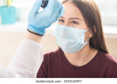 Doctor Shines In The Eye Of A Patient Teenager At A Reception In A Medical Clinic, Examination And Correction Of Vision