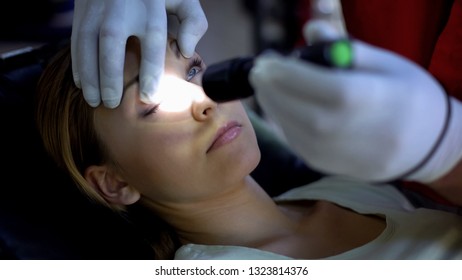 Doctor Shining Light Into Patient Eye, Testing Pupil Reflexes, First Aid Closeup