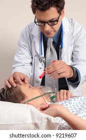 A Doctor Shining A Light Into A Patient Eyes Checkup Examination