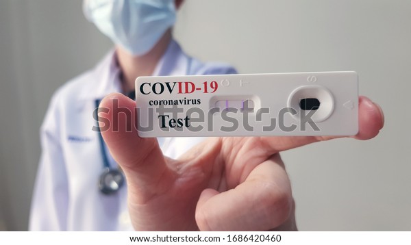 Doctor show rapid laboratory COVID-19 test for\
diagnosis new Corona virus infection(novel corona virus disease\
2019 or COVID)from Wuhan, ready for screening and treatment.\
Pandemic infectious\
concept