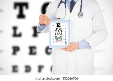 Doctor Showing A Digital Tablet Against Eye Test