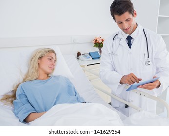 Doctor Showing Digital Tablet To Patient