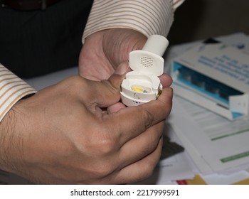 Doctor Showing How To Use Dry Powder Inhaler Or DPI Device For Deliver Medication To The Lungs In The Form Of A Dry Powder To Treat Respiratory Diseases Such As Asthma, Bronchitis, Emphysema And COPD