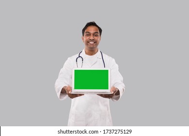 Doctor Showing Laptop Green Screen Isolated. Indian Man Doctor with Laptop in Hands. Online Medicine Concept - Powered by Shutterstock