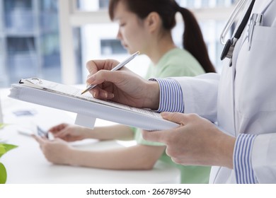 Doctor Showing Medical Results To His Female Woman 