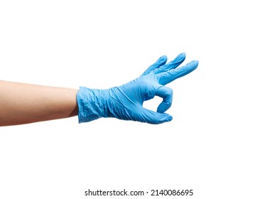 Doctor showing OK gesture while wearing latex gloves - Shutterstock ID 2140086695