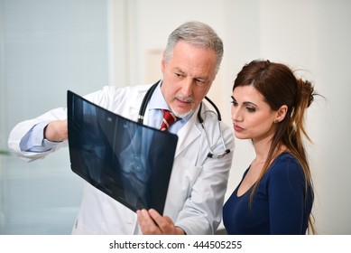 Doctor showing a radiography to his patient