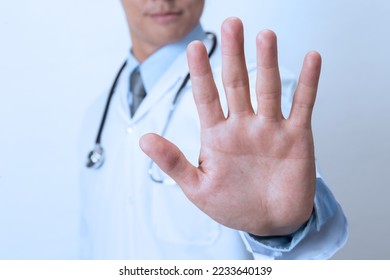 Doctor  showing stop sign on white background - Shutterstock ID 2233640139