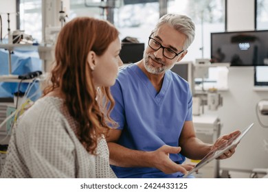 Doctor showing teenage patient MRI scan on tablet, discussing test result in emergency room. - Powered by Shutterstock