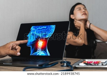 Doctor showing a x-ray of pain in the neck. Migraine Headache and backache. Woman patient in the background