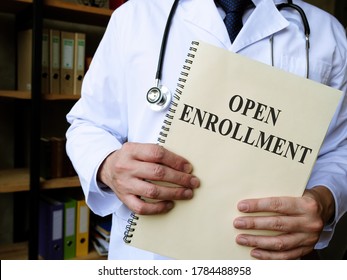 Doctor Shows Annual Open Enrollment Stack Of Papers.