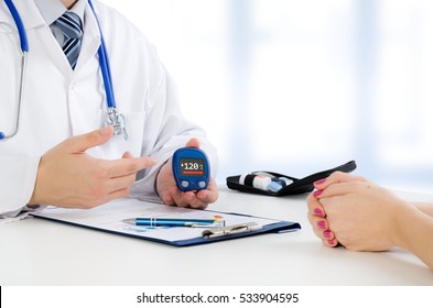 Doctor Shows Glucometer With Glucose Level. Doctor Patient Diabetes Glucometer Blood Glucose Office Hand Concept