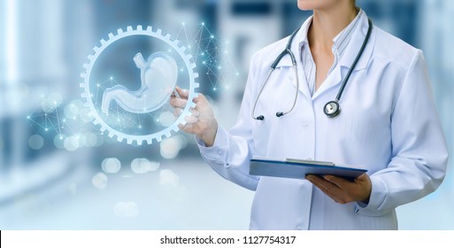 Doctor Shows How It Works Digestive System On Blurred Background.