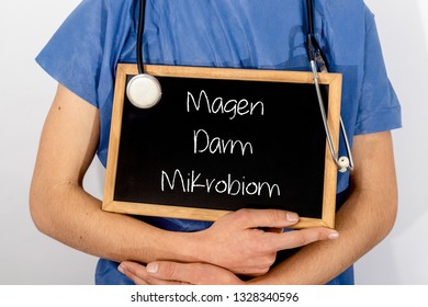 Doctor shows information on blackboard: Magen Darm Mikrobion.  Medical concept.