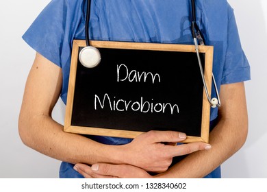 Doctor shows information on blackboard: Darm Microbiom.  Medical concept.