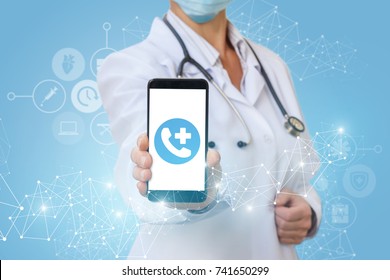 Doctor shows on the phone call icon on blurred background.