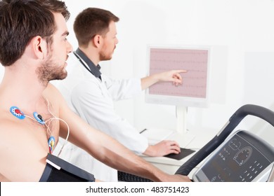 Doctor shows the patient the ECG recording of the electrical activity of the heart