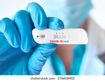 Doctor shows rapid laboratory COVID-19 test for detection of IgM and IgG antibodies to Novel Coronavirus, SARS-CoV-2 with positive result. Immunity against novel pathogen causing worldwide pandemics.