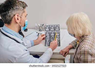 Doctor Shows A Senior Patient A CT Scan Of Her Lungs. Pneumonia, Coronavirus, Lung Disease