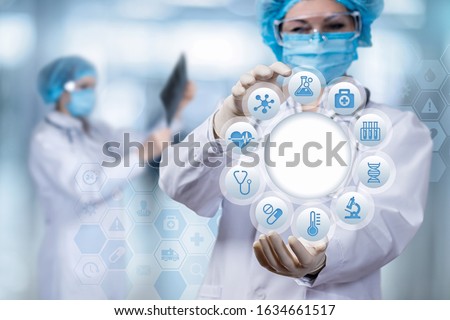 The doctor shows the structure of medical icons on a blurred background.