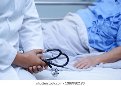 Doctor Sit Down Near Asian Senior Or Elderly Old Lady Woman Patient With With Love, Care, Helping, Encourage And Empathy While Lying On Bed In Nursing Hospital Ward : Healthy Strong Medical Concept 
