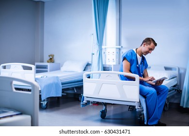 Doctor Sitting On Hospital Bed Using Stock Photo 630431471 | Shutterstock