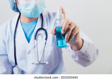 Doctor Sprays Hand Sanitizer Or Gel Dispenser To Clean Hands And Kill Viruses And Bacteria Into The Air After Patients Visited. Medical Health People And Illness Protective Concept. 