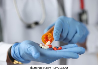 Doctor Sprinkles The Pills On Gloved Hand. New Drug Development Concept