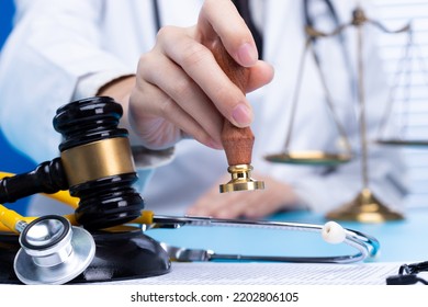 Doctor stamp approval with authority to patient to death. Law legal protect medical doctor from criminal court judgement. Concept with stethoscope balance scale mullet hammer, copy space - Shutterstock ID 2202806105