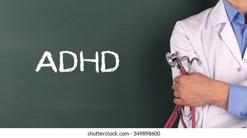 Doctor Standing Front Of Blackboard Written ADHD