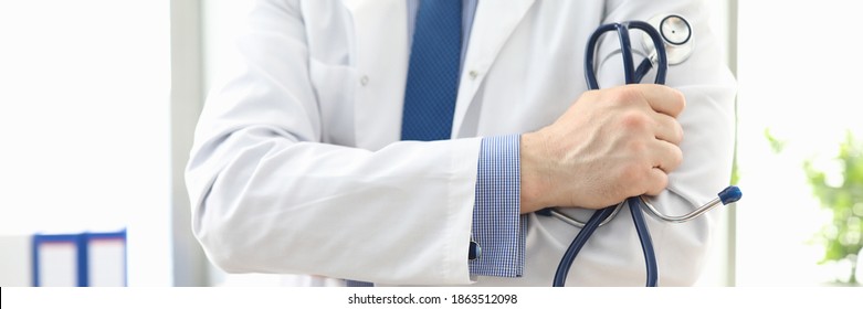 Doctor standing in office with stethoscope in his hand. Platform for online consultation with doctors. Family doctor appointment online. Pandemic disease prevention. Elucidation medical history - Shutterstock ID 1863512098