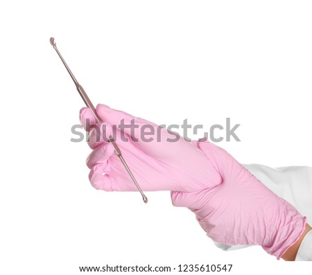 Doctor in sterile gloves holding medical instrument on white background