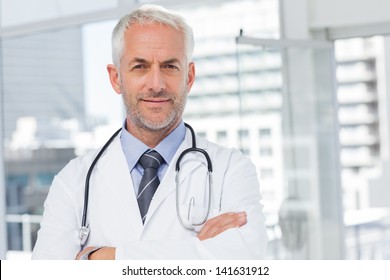 Doctor with stethoscope around his neck looking at the camera