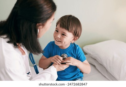 Doctor, stethoscope and child in hospital for healthcare, health and wellness with medical exam. Female pediatrician, assessment and patient in clinic for heart, lungs and cardiology with breathing - Powered by Shutterstock