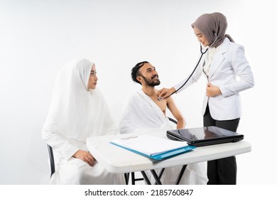 A Doctor With A Stethoscope Examines A Male Pilgrim In The Room