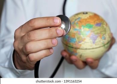 Doctor with stethoscope and globe in his hand. Medical network and health care in Europe and Africa, concept of world medicine, epidemic control, covid-19 coronavirus