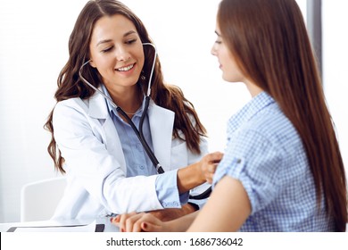 Doctor With A Stethoscope In The Hand Examining Her Female Patient. Health Care, Cardiology And Medicine Concepts